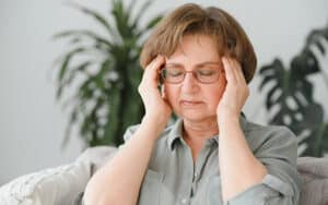 Middle aged woman suffering from migraine during menopause