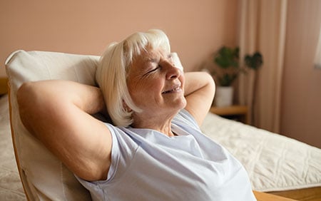 Older woman relaxing in bed