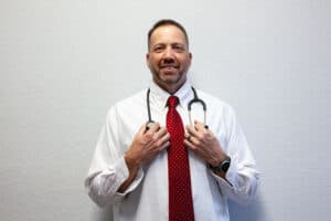 Michael Durham of Age Well holding a stethoscope around his neck